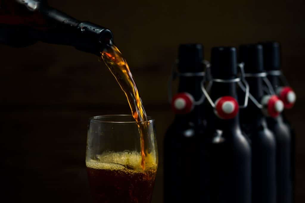 Beer glasses and beer bottles on a wooden background